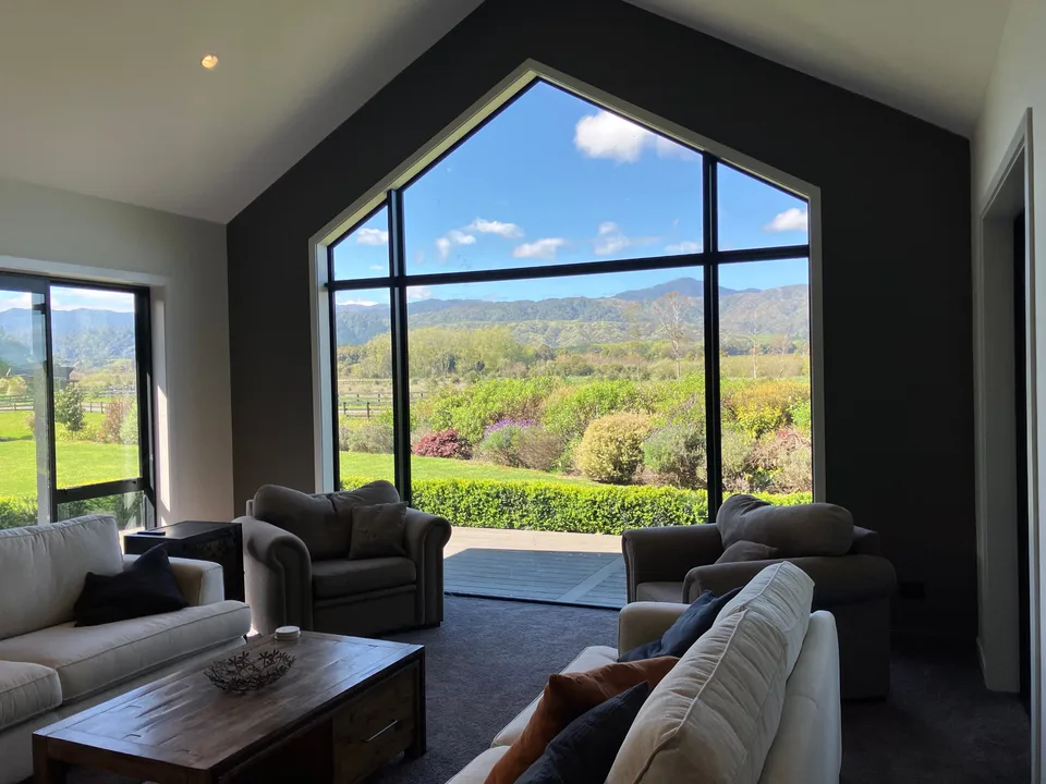 Living – raised ceiling and feature windows capture the view